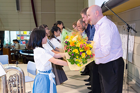 Members of the quintet receive bouquets and commemorative gifts.
